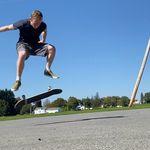 an action shot of me doing a kickflip on a skateboard